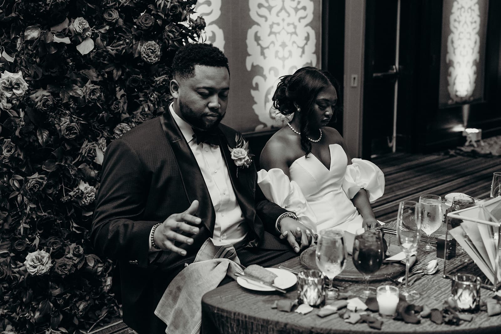 couple praying during wedding reception toast