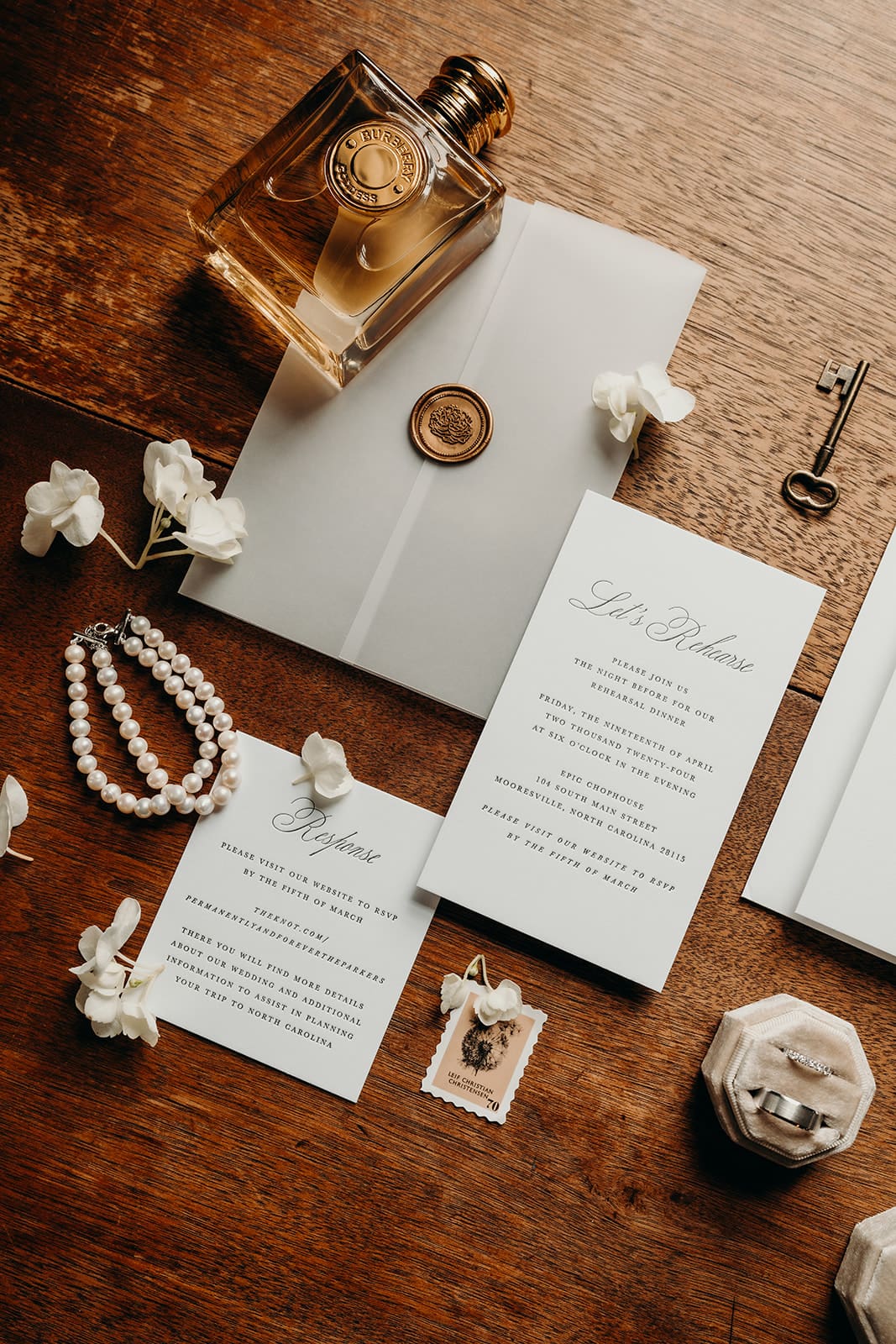 wedding detail photos including invitations, jewelry, and perfume