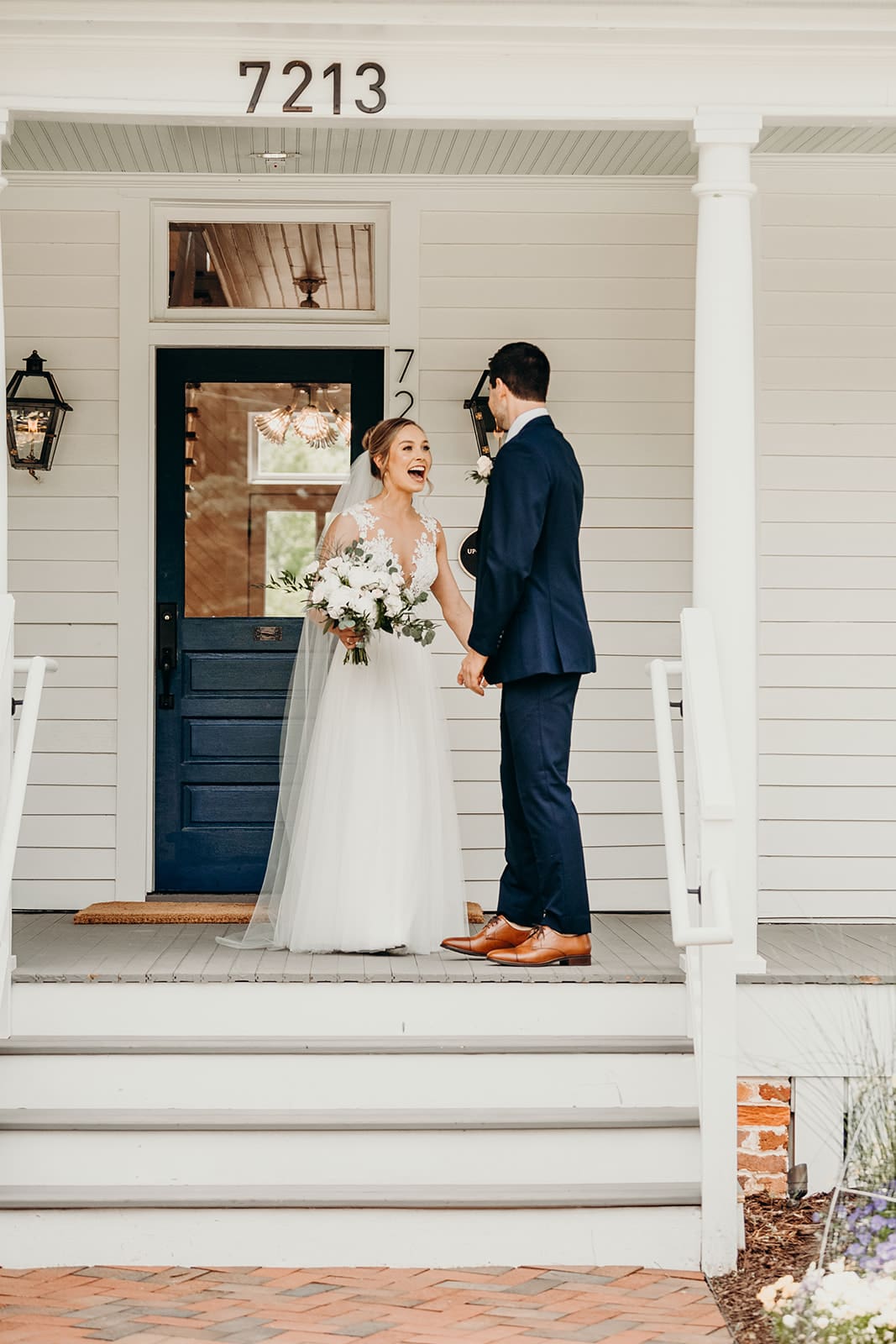 couple doing first look on front porch of house