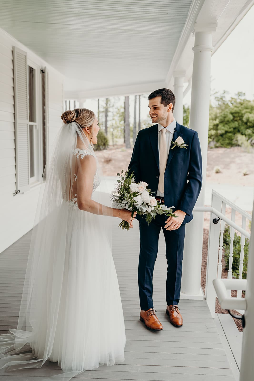 wedding day first look on porch - groom's reaction