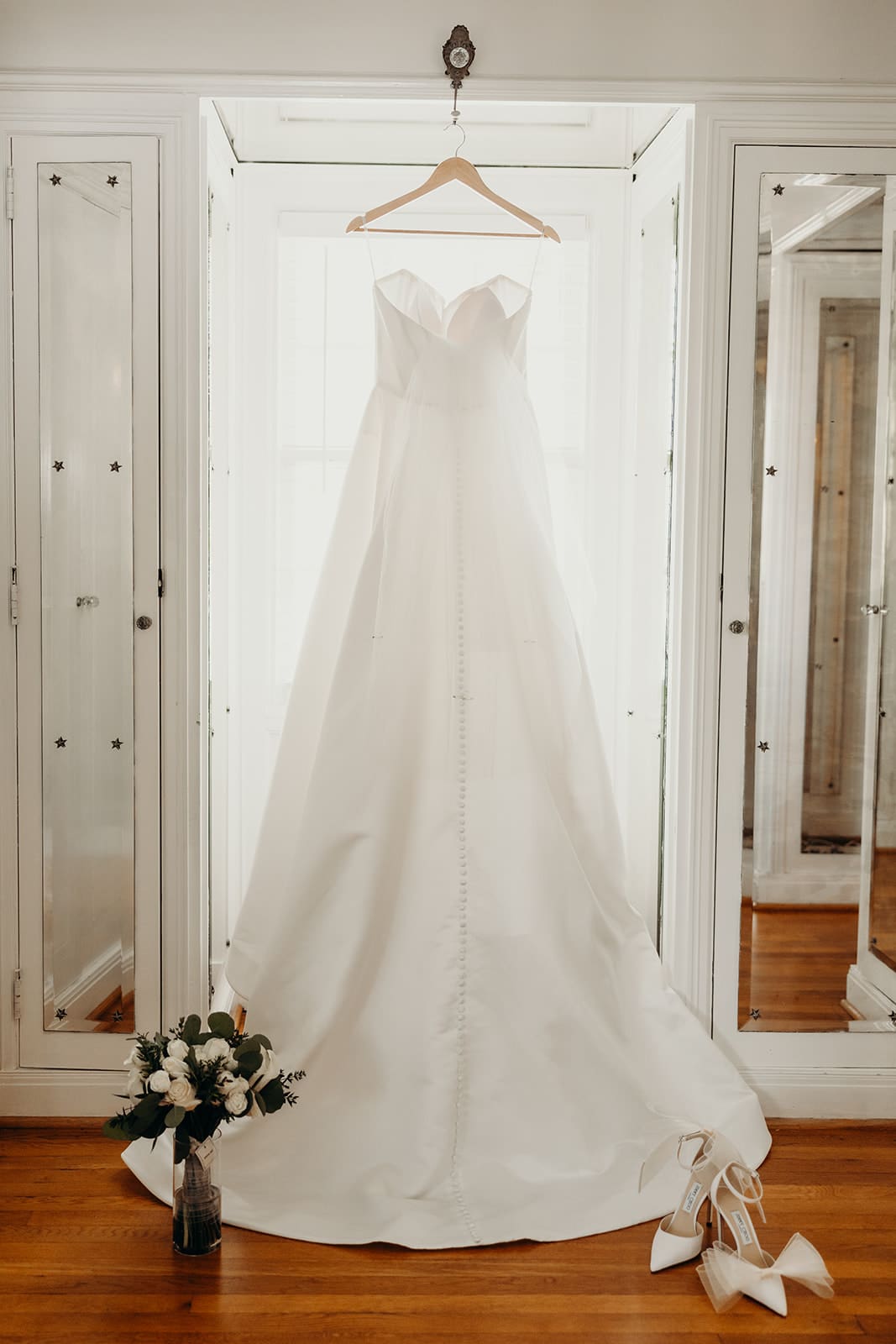 wedding dress hanging in window